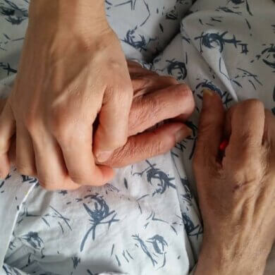 holding on to old person's hand