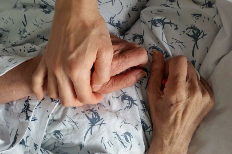 holding on to old person's hand